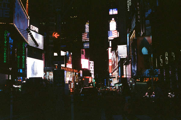 Peering out of the side window of a cab.
 - Times Square, NYC